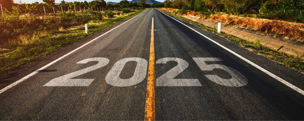 An open road stretching into the horizon with the year '2025' painted on the asphalt, symbolizing a journey toward the future. Surrounded by greenery and mountains in the distance under a warm sunset glow.